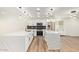 Gourmet kitchen featuring stainless steel appliances, white cabinets, and quartz countertops at 4701 N 63Rd Dr, Phoenix, AZ 85033