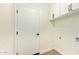 Clean laundry room featuring white cabinets and luxury vinyl floors at 4701 N 63Rd Dr, Phoenix, AZ 85033