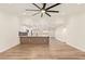 Spacious living room boasts an open floor plan, wood floors, and a modern ceiling fan at 4701 N 63Rd Dr, Phoenix, AZ 85033
