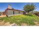 Expansive backyard features lush green grass, mature shade tree, and block fencing at 5343 W Coronado Rd, Phoenix, AZ 85035