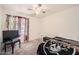 Relaxing bedroom with carpet flooring, a window with curtains, and a ceiling fan at 5343 W Coronado Rd, Phoenix, AZ 85035