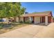 Charming single-story home with a concrete driveway and a well-maintained lawn and mature tree at 5343 W Coronado Rd, Phoenix, AZ 85035