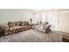 Cozy living room with plush floral sofas, light-colored carpet, and a large window at 5343 W Coronado Rd, Phoenix, AZ 85035