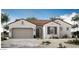Charming single-story home featuring a tile roof, stucco walls, and a two-car garage at 5705 W St Moritz Ln, Glendale, AZ 85306