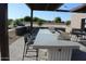 Outdoor kitchen area with long bar, grilling area and seating for many at 5705 W St Moritz Ln, Glendale, AZ 85306