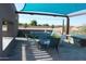 Outdoor patio featuring shaded seating area with synthetic grass, ping pong table and string lights at 5705 W St Moritz Ln, Glendale, AZ 85306