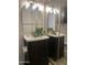 Dual sink vanity in a well-lit bathroom with tile flooring at 602 N May St # 65, Mesa, AZ 85201