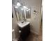 Cozy powder room featuring a new black vanity and framed mirrors at 602 N May St # 65, Mesa, AZ 85201