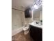 Well-lit bathroom featuring a tub with shower and a dark vanity at 602 N May St # 65, Mesa, AZ 85201
