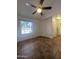 Spacious bedroom with tile flooring, a ceiling fan, and a large window for natural light at 602 N May St # 65, Mesa, AZ 85201