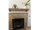 Classic fireplace with brick surround and a wooden mantel at 602 N May St # 65, Mesa, AZ 85201