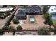 An aerial view shows a house under construction with a pool in the backyard and surrounding greenery at 6426 E Turquoise Ave, Paradise Valley, AZ 85253
