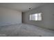 Bright bedroom with a window, awaiting your personal design touches at 6426 E Turquoise Ave, Paradise Valley, AZ 85253