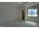 A minimalist bedroom with neutral walls and a window awaits personal touches at 6426 E Turquoise Ave, Paradise Valley, AZ 85253