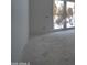 A bedroom features a window and neutral walls, ready for new finishes at 6426 E Turquoise Ave, Paradise Valley, AZ 85253