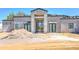 A modern home's front exterior features a stylish entry and an unfinished roof at 6426 E Turquoise Ave, Paradise Valley, AZ 85253