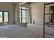 Unfinished room showcasing a large window and framed doorway ready for paint and flooring at 6426 E Turquoise Ave, Paradise Valley, AZ 85253