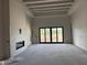 Unfinished living room with modern fireplace and sliding glass doors, awaiting personalized interior design at 6426 E Turquoise Ave, Paradise Valley, AZ 85253