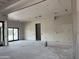 An unfinished living room features bare walls, ceilings, and a large sliding door for customization at 6426 E Turquoise Ave, Paradise Valley, AZ 85253