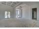 A spacious living room features a tray ceiling and large glass doors for ample light at 6426 E Turquoise Ave, Paradise Valley, AZ 85253