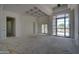 A bright living room boasts high ceilings and large windows, awaiting personalization at 6426 E Turquoise Ave, Paradise Valley, AZ 85253