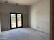 An unfinished room features blank walls and a large black French door, offering customization opportunities at 6426 E Turquoise Ave, Paradise Valley, AZ 85253
