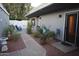 Landscaped backyard with lush green plants and a charming patio area at 8848 N New World Dr, Glendale, AZ 85302
