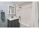 Bright bathroom featuring a modern vanity, bathtub with sleek white tile, and updated fixtures at 8848 N New World Dr, Glendale, AZ 85302