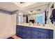 Stylish bathroom with dual sinks, marble countertops, custom cabinets, modern fixtures, and a combined shower and bathtub at 8848 N New World Dr, Glendale, AZ 85302