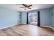 Bright bedroom with hardwood floors, ceiling fan, and a sliding glass door leading to a private outdoor patio at 8848 N New World Dr, Glendale, AZ 85302