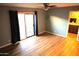 Bedroom with wood floors, ceiling fan, and sliding glass doors to the backyard at 8848 N New World Dr, Glendale, AZ 85302
