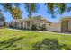 Inviting single-story home featuring desert landscaping, shade trees, and a private gated entrance in a well-maintained community at 8848 N New World Dr, Glendale, AZ 85302