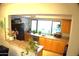 Well-lit kitchen with wood cabinets, stainless steel appliances, and a breakfast bar at 8848 N New World Dr, Glendale, AZ 85302