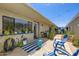 Private outdoor patio features a blue accent wall, string lights, and comfortable seating for relaxing and entertaining at 8848 N New World Dr, Glendale, AZ 85302
