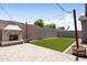 Large backyard with artificial turf, a unique outdoor fireplace, and a basketball hoop at 10165 E Gamma Ave, Mesa, AZ 85212