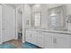 Bathroom features dual sinks with granite counters, white cabinets and a glass enclosed shower, complemented by tile floors at 10165 E Gamma Ave, Mesa, AZ 85212