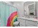 Modern bathroom with colorful shower curtain, granite countertop and stylish finishes at 10165 E Gamma Ave, Mesa, AZ 85212