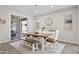Bright dining room features a rustic wooden table with bench seating, modern light fixture and sliding door to backyard at 10165 E Gamma Ave, Mesa, AZ 85212