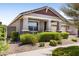 Well-maintained single-Gathering home with desert landscaping and a charming front porch at 10165 E Gamma Ave, Mesa, AZ 85212