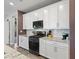 Contemporary kitchen with stainless appliances, granite countertops, white cabinetry, and ample space for cooking at 10165 E Gamma Ave, Mesa, AZ 85212