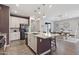 Open-concept kitchen with a large island, granite countertops, modern appliances, and an adjacent dining area at 10165 E Gamma Ave, Mesa, AZ 85212