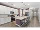 Spacious kitchen featuring a large island with seating, granite countertops, and stainless steel appliances at 10165 E Gamma Ave, Mesa, AZ 85212