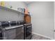 Laundry room with modern appliances, a large folding shelf, and wood flooring at 10165 E Gamma Ave, Mesa, AZ 85212