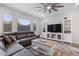 Comfortable living room featuring a plush leather couch, a ceiling fan, and a stylish coffee table on a patterned rug at 10165 E Gamma Ave, Mesa, AZ 85212