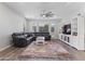 Inviting living room with a plush leather sofa, ceiling fan, neutral paint, and wood-look floors at 10165 E Gamma Ave, Mesa, AZ 85212
