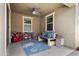 Cozy covered patio featuring comfortable seating, rug, ceiling fan, and a playful area at 10165 E Gamma Ave, Mesa, AZ 85212
