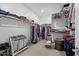 Organized walk-in closet with ample hanging space, shelving, and a designated area for shoes and accessories at 10165 E Gamma Ave, Mesa, AZ 85212