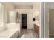 Sun-filled bathroom with dual sinks, walk-in shower, soaking tub and modern vanity at 1028 S Valle Verde --, Mesa, AZ 85208