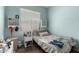 Bright bedroom with soft blue walls, natural light, and a peaceful atmosphere for restful nights at 1028 S Valle Verde --, Mesa, AZ 85208