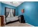 Cozy bedroom with blue walls, carpet floors, window with dark curtains and compact storage at 1028 S Valle Verde --, Mesa, AZ 85208